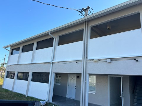 A white building with a blue sky in the background.