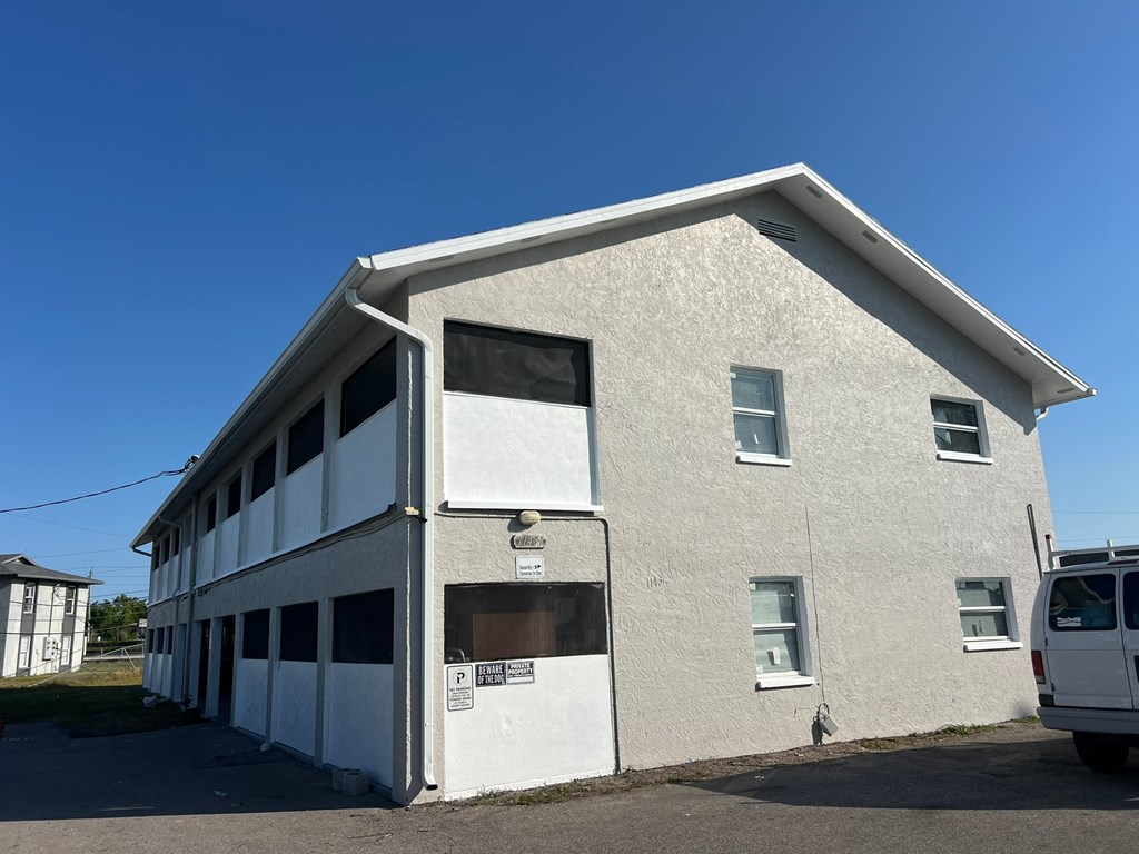 A white building with a clear blue sky in the background.