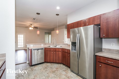 a kitchen with stainless steel appliances and wooden cabinets