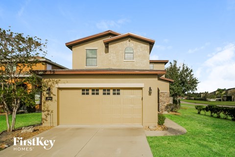 a beige house with a tan garage door