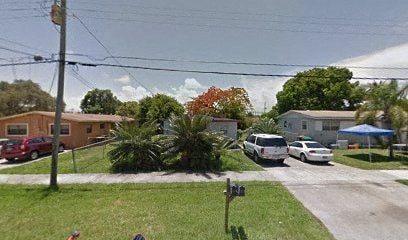 A street view with cars and houses.