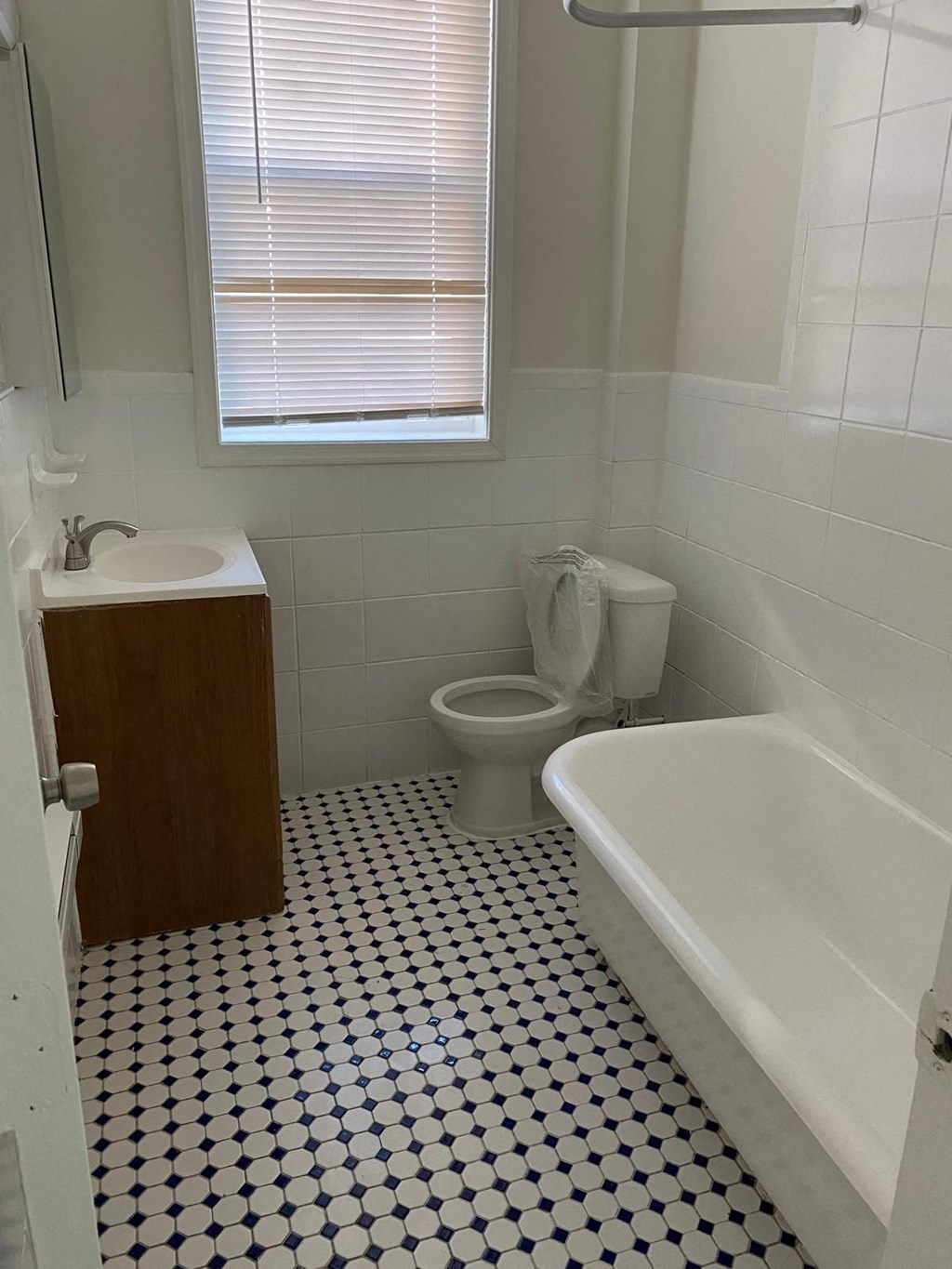a bathroom with a toilet and a sink and a bath tub