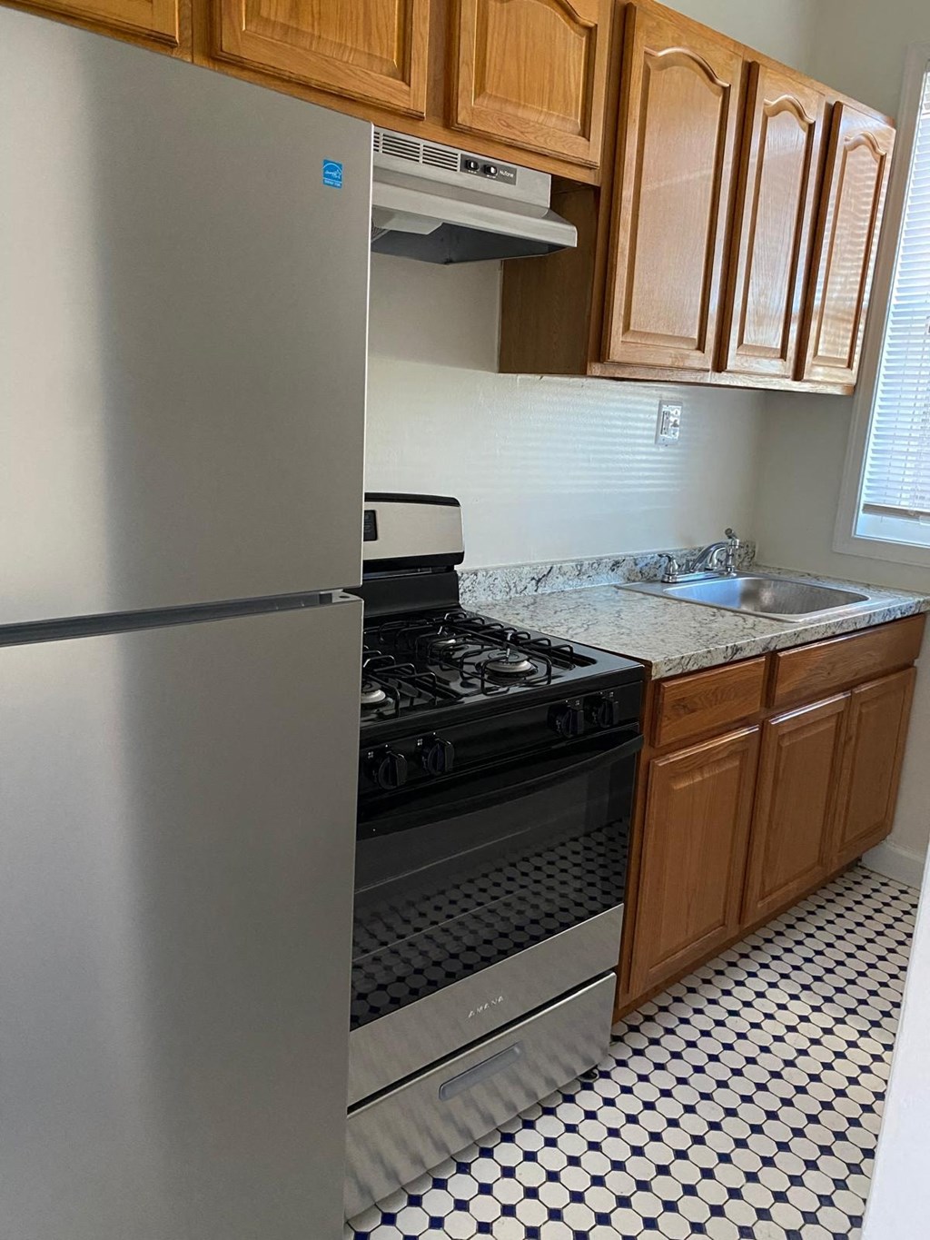 a kitchen with a stove and a refrigerator