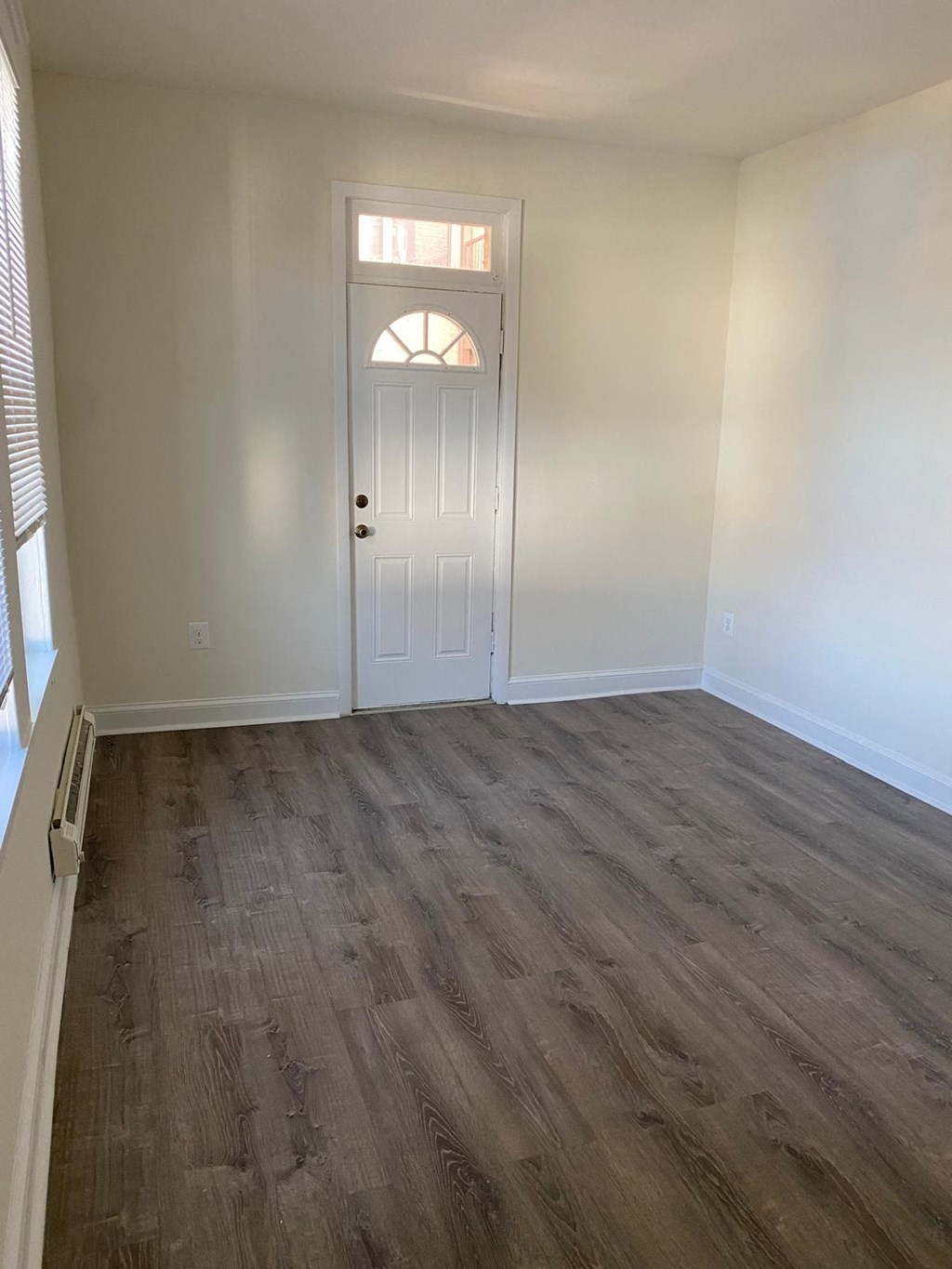 a empty room with white walls and a white door