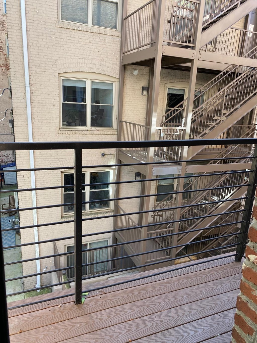 a balcony with a view of a building with stairs