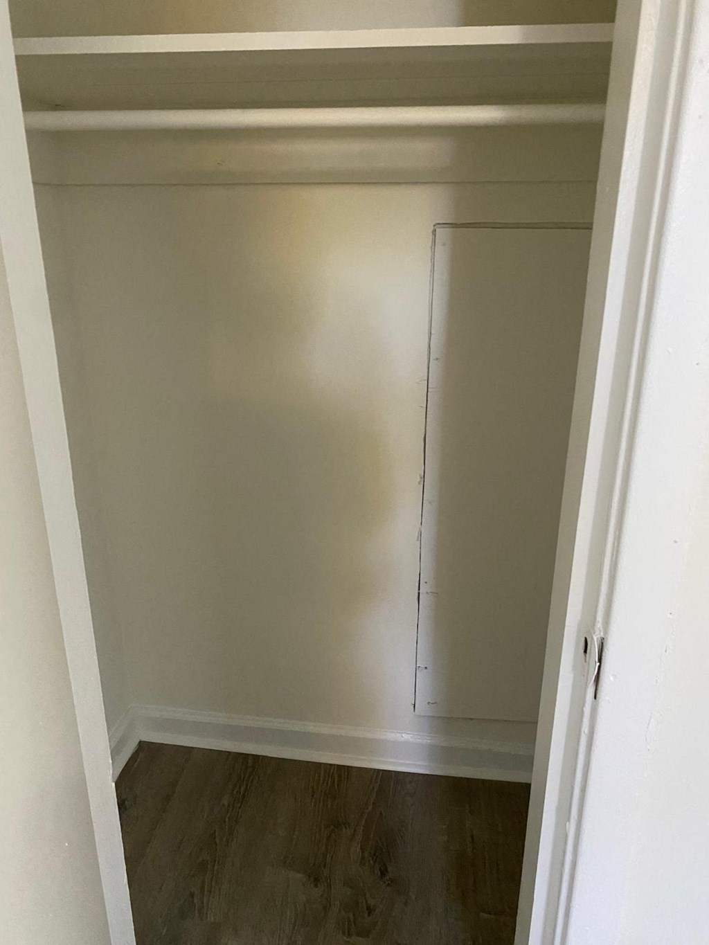a room with a closet and a wooden floor