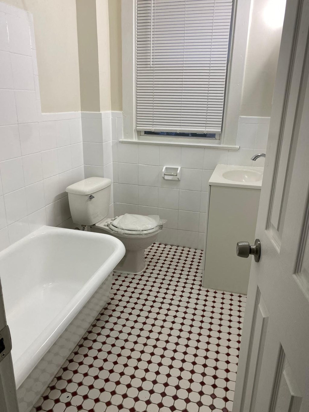 a bathroom with a toilet and a bath tub and a sink