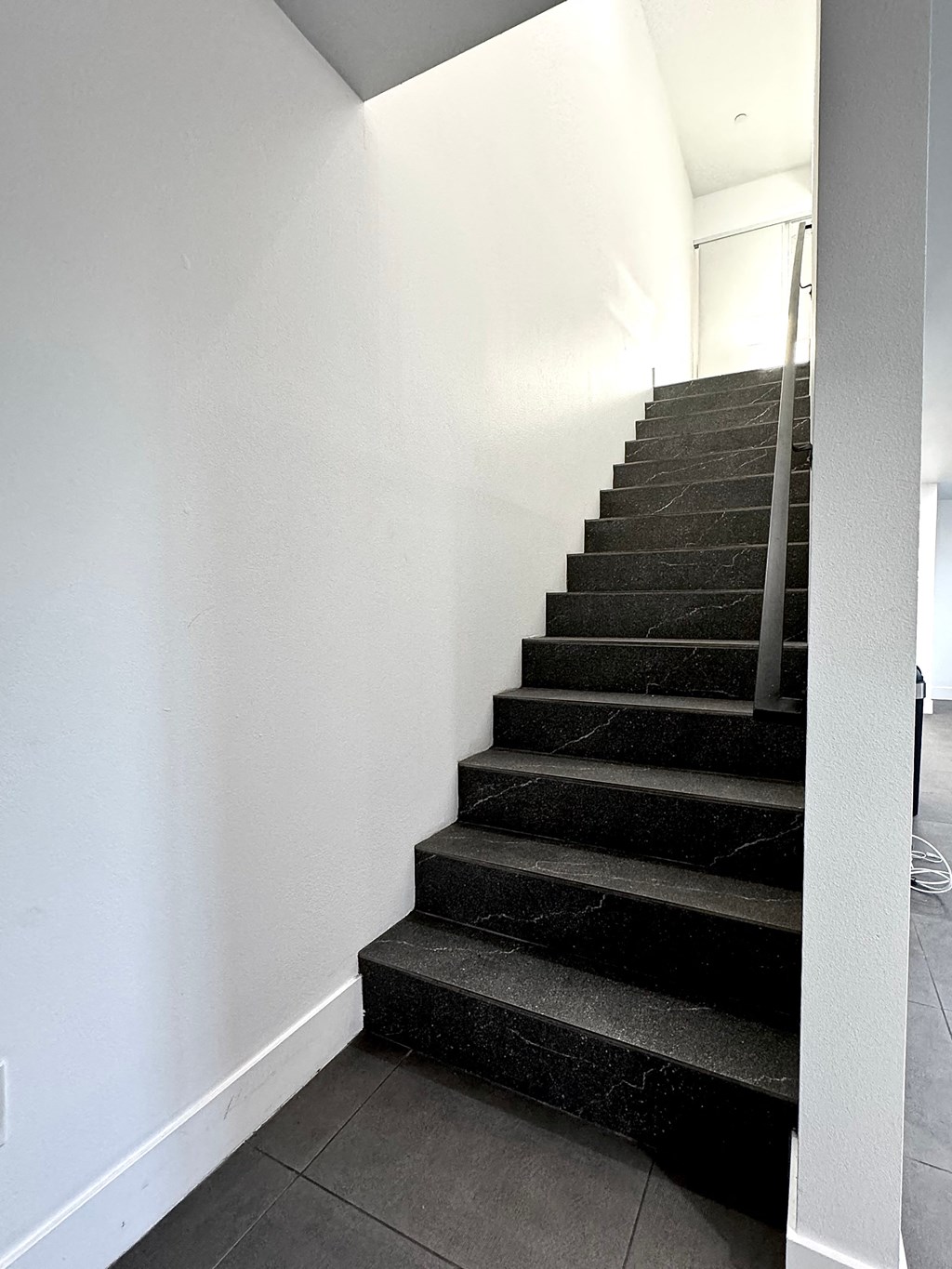 a flight of stairs in a home with white walls