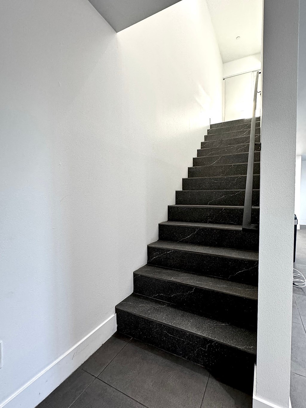 a flight of stairs in a home with white walls