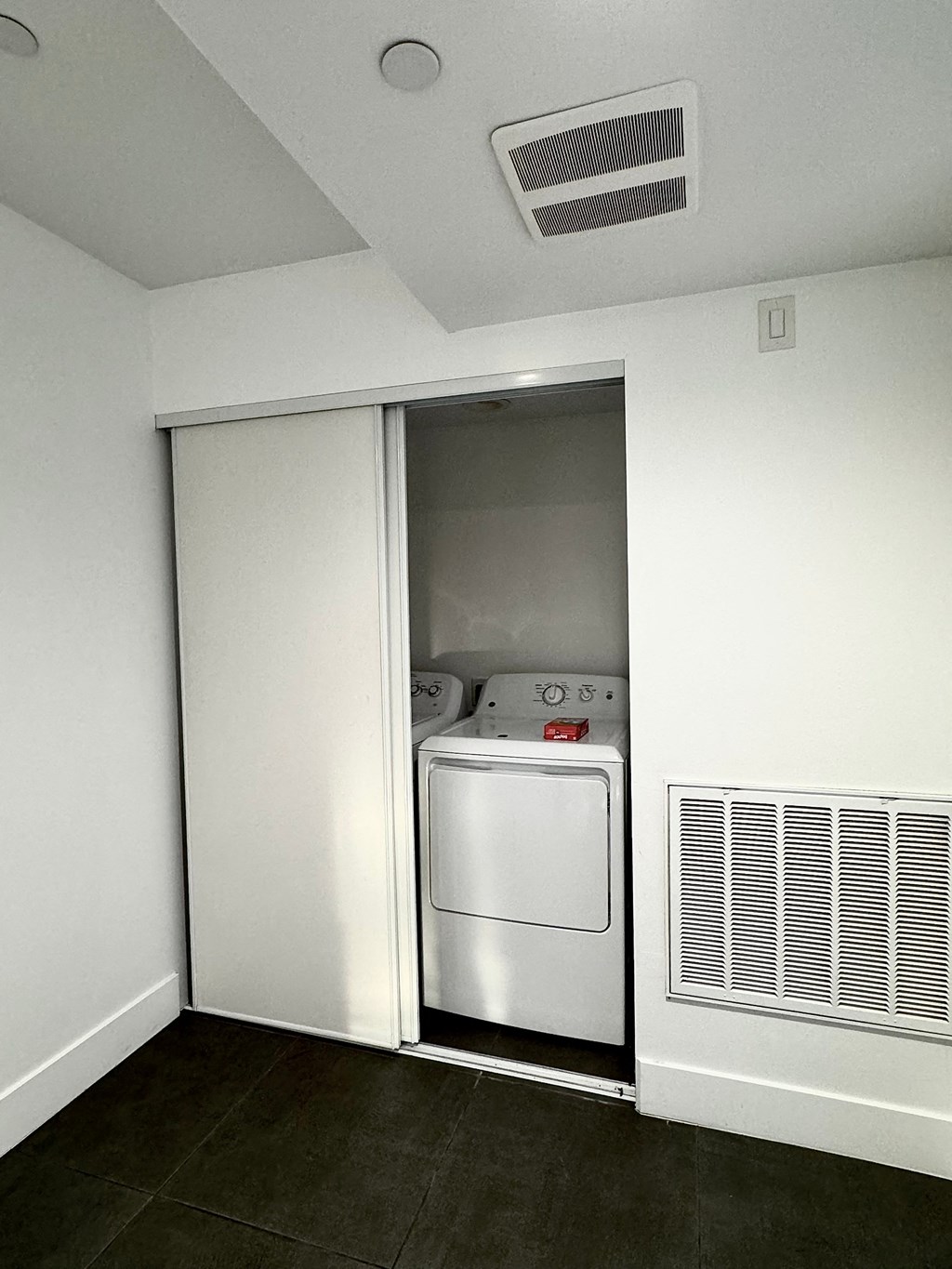a white room with a washer and a dryer in it