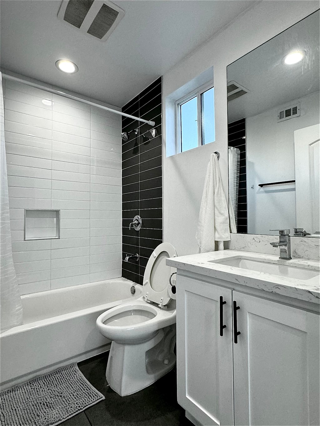 a bathroom with a toilet and a tub and a sink