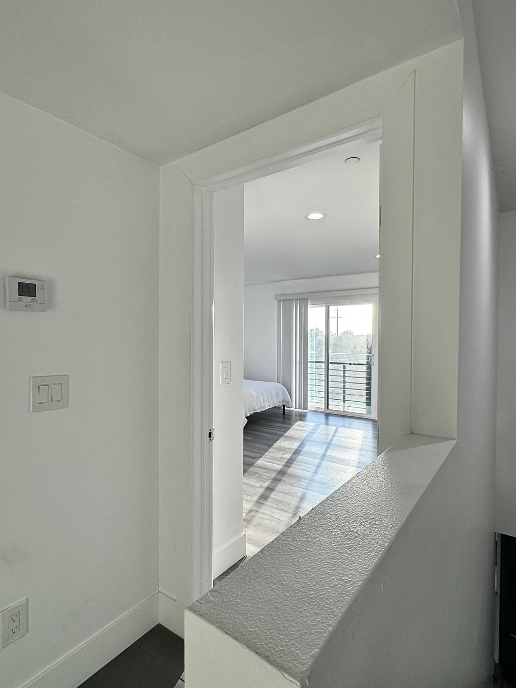 a view of a bedroom from the hallway of a house