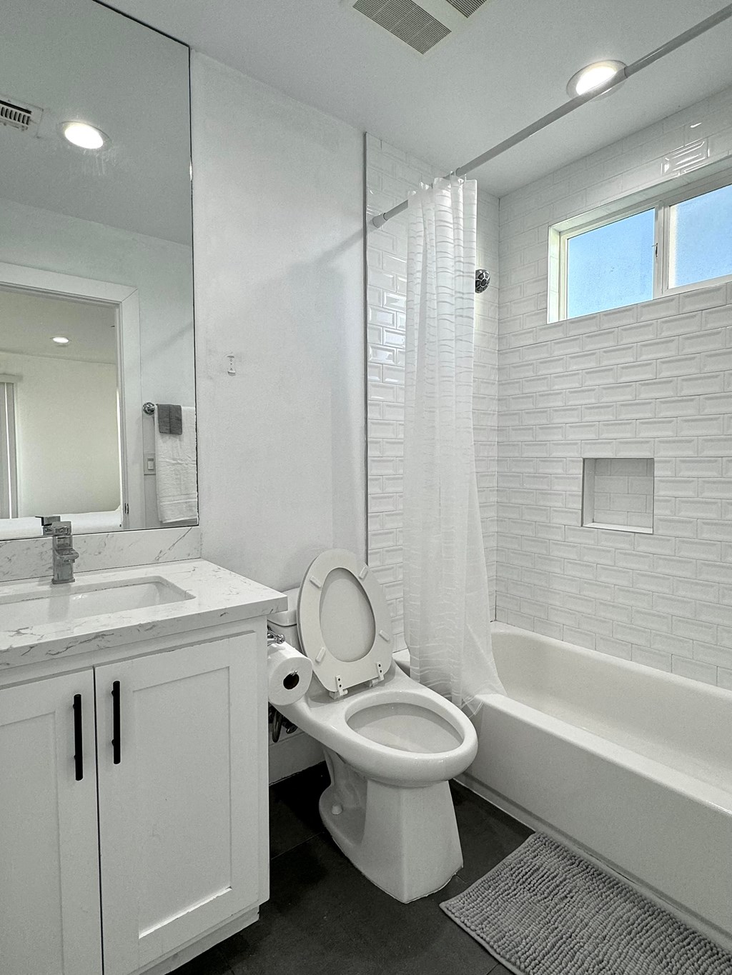 a bathroom with a toilet and a sink and a shower