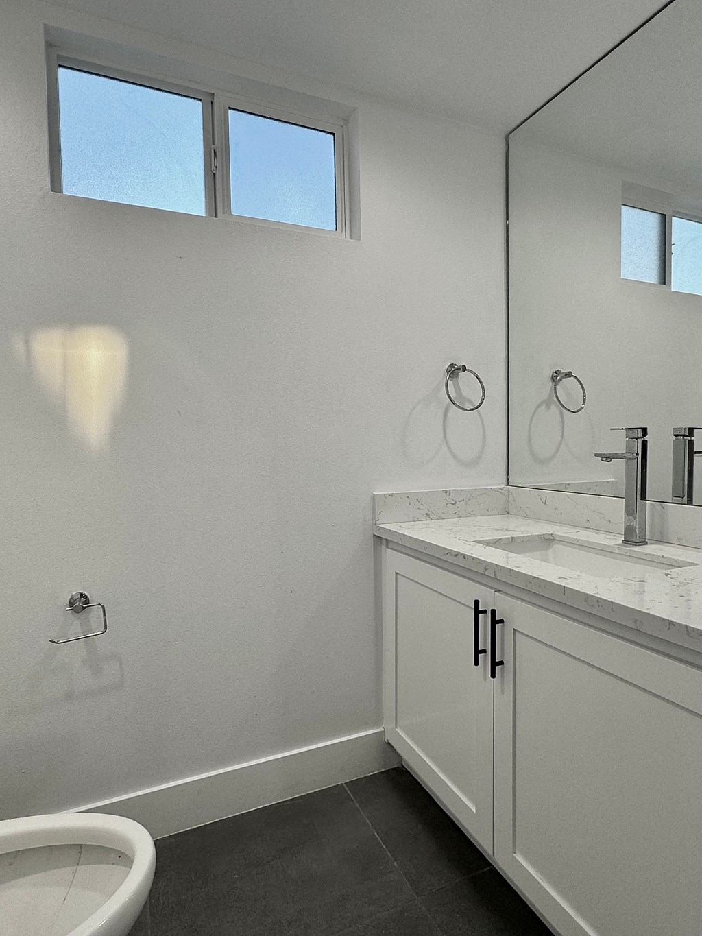a white bathroom with a sink and a toilet