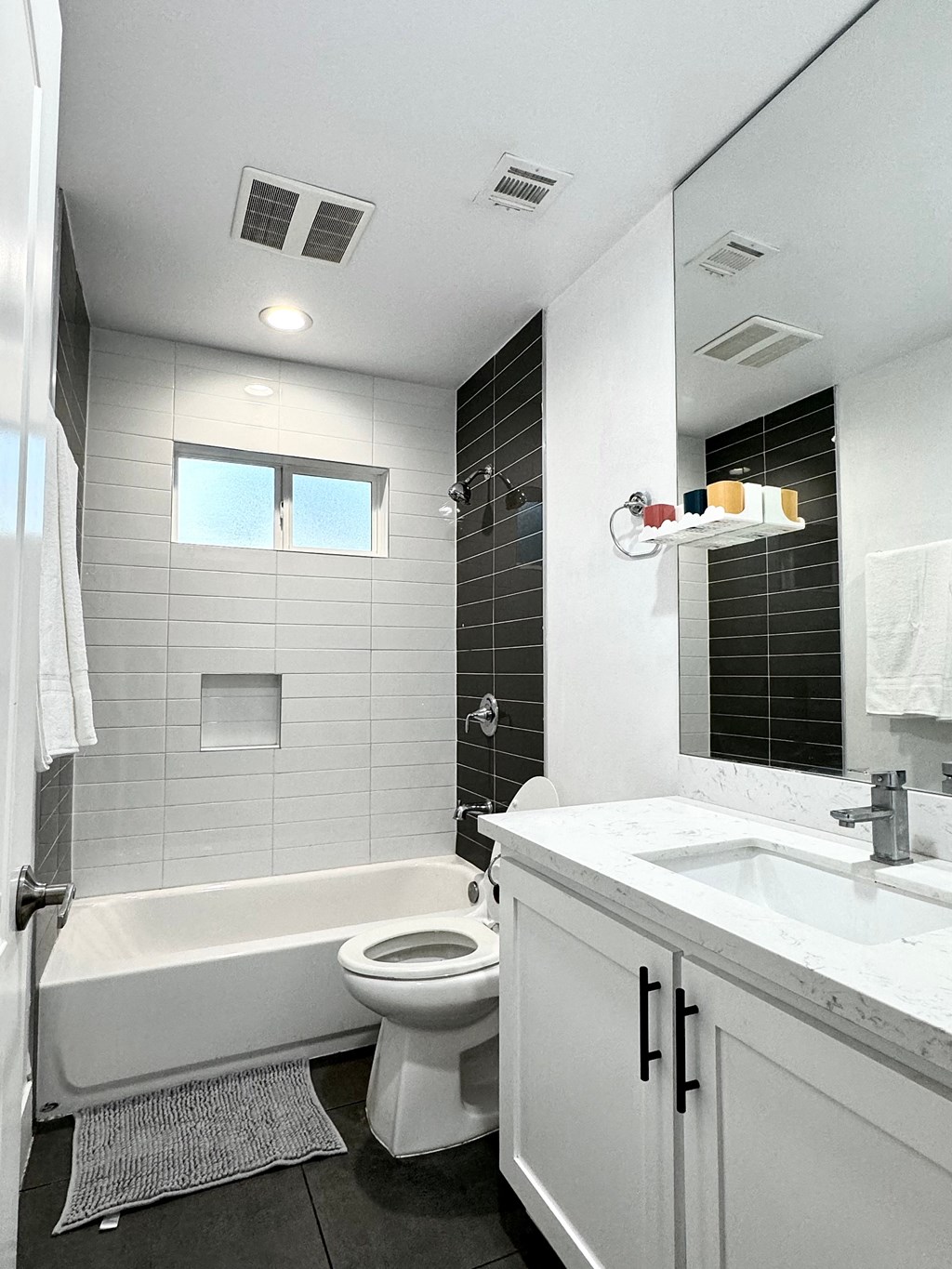 a white bathroom with a tub and a toilet and a sink
