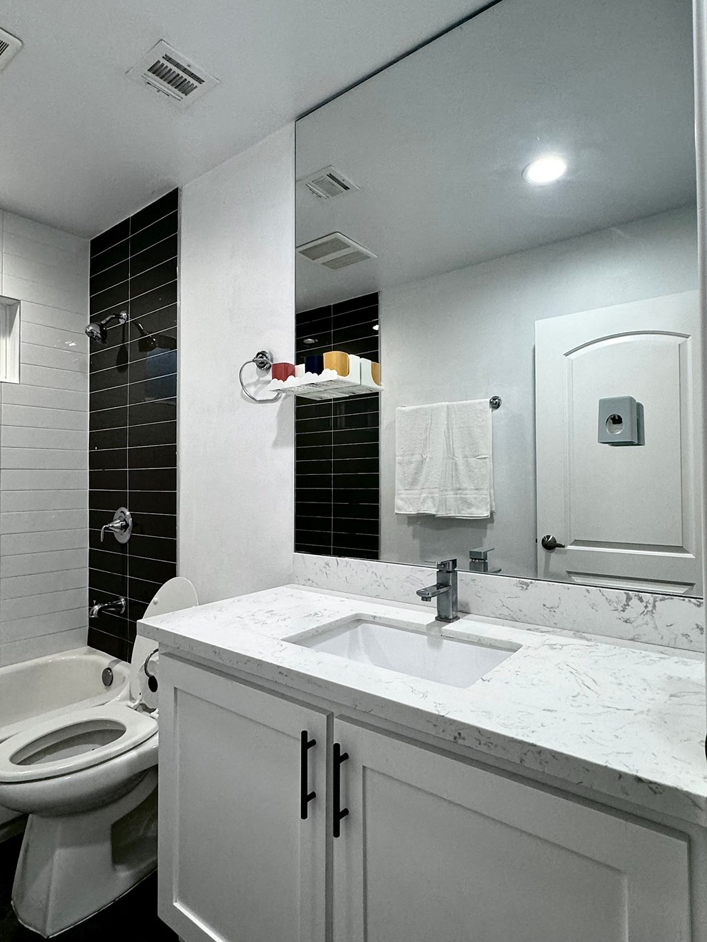 a white bathroom with a sink and a toilet