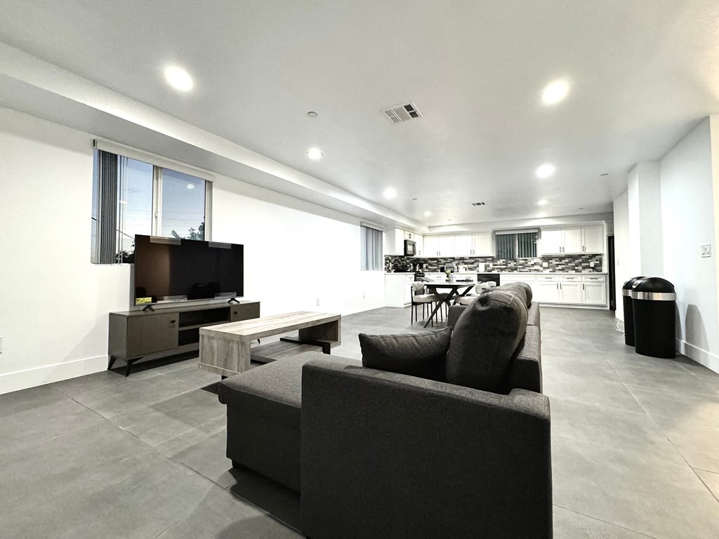 a large living room with a couch and a television