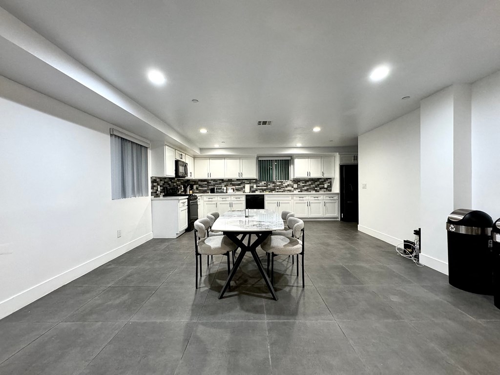 a dining room with a table and chairs and a kitchen