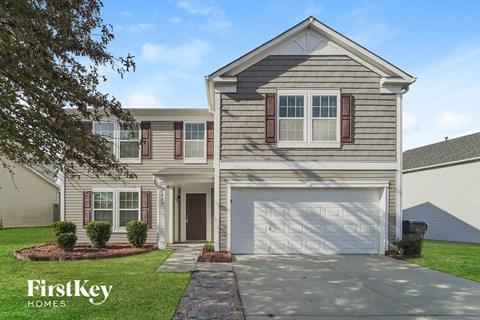 a beige house with a white garage door