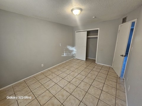 A room with a Galaxy S23 Ultra phone on the floor.