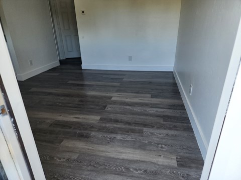A room with a wooden floor and white walls.