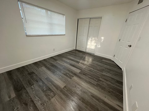 A room with a wooden floor and white walls.