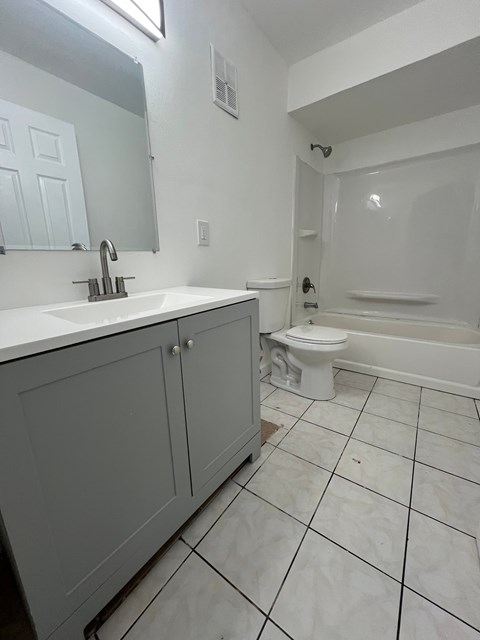A white bathroom with a toilet and sink.