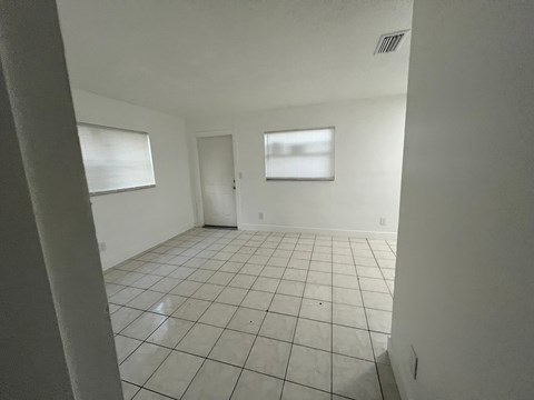 A room with white walls and a tiled floor.