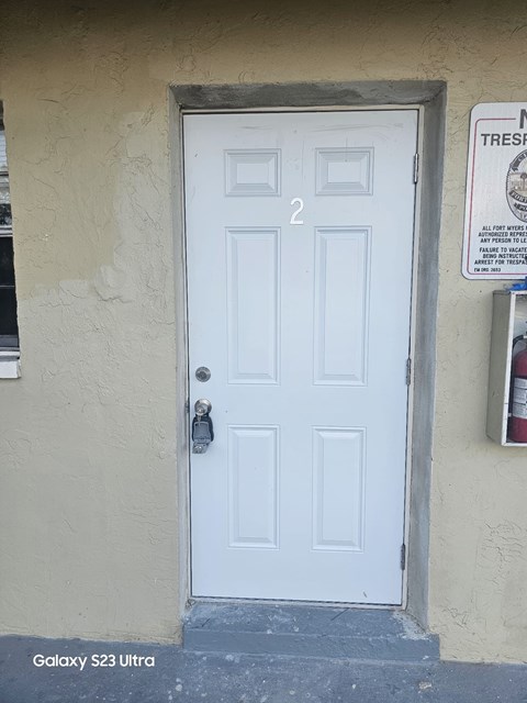 A white door with a black handle and a number 2 on it.