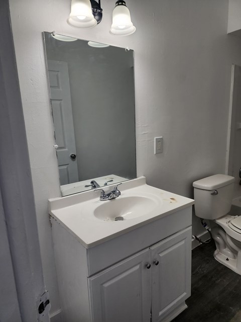 A white bathroom sink with a mirror above it.