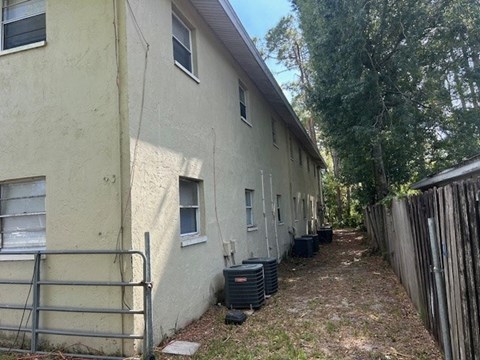 A white building with a gate in front of it.