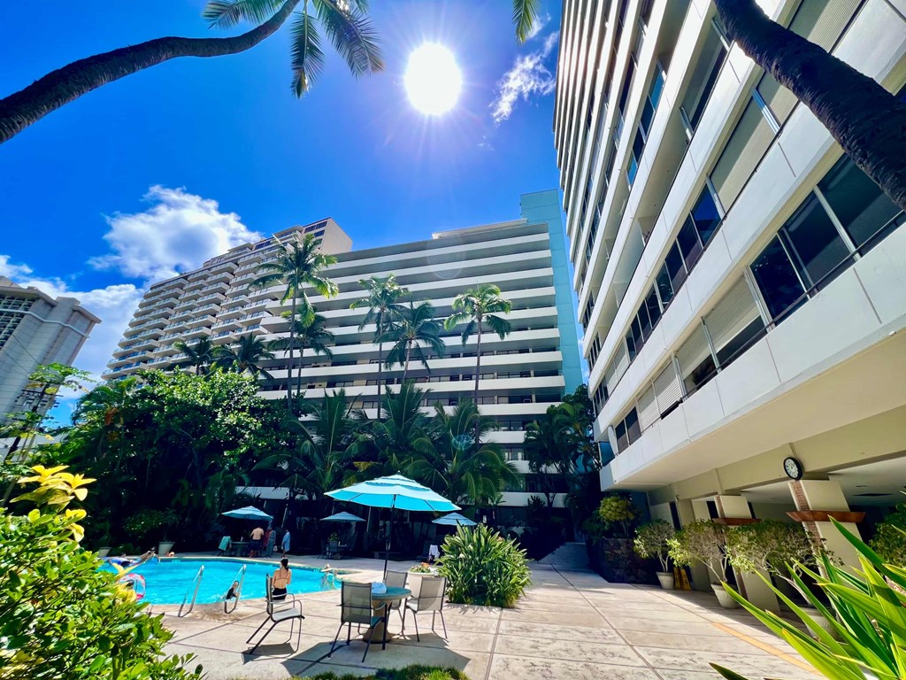 a swimming pool at a hotel in front of a building