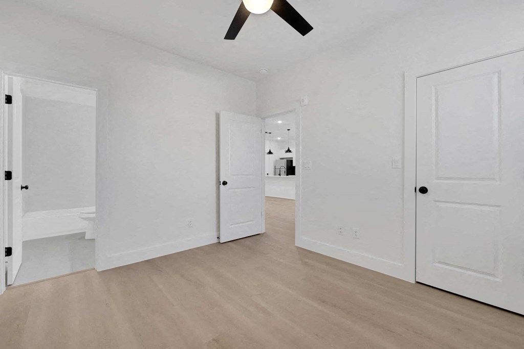 a bedroom with two closets and a door to a bathroom