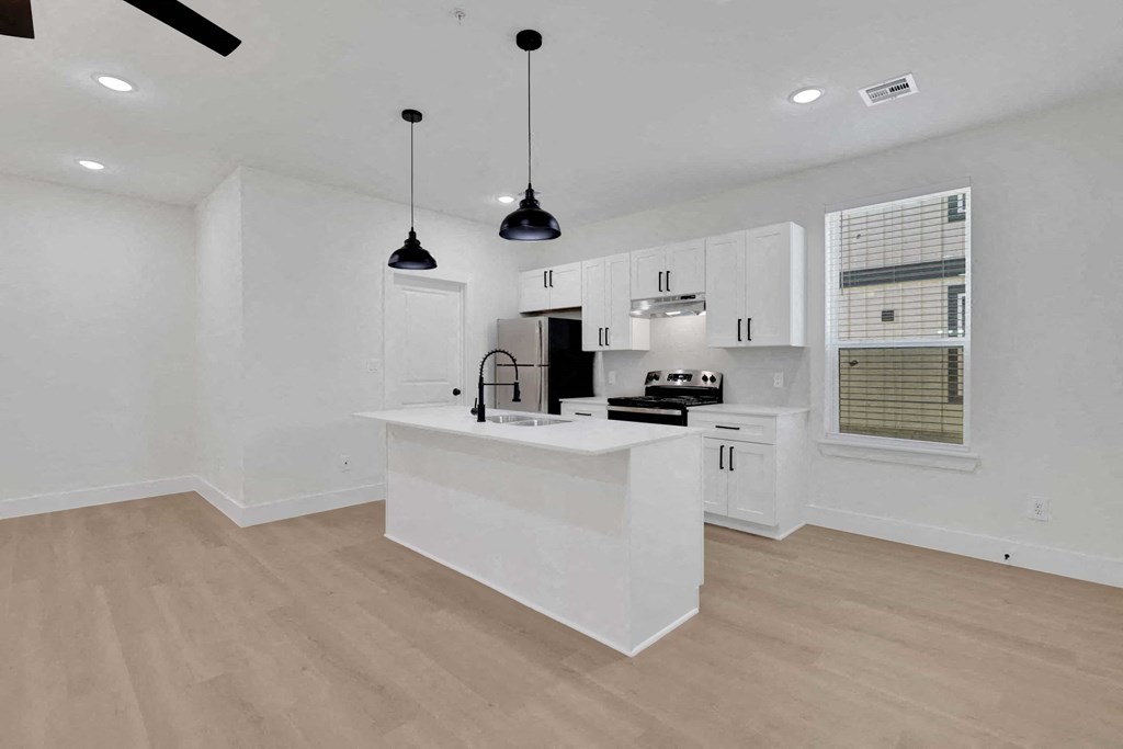 a kitchen with white cabinets and a white counter top