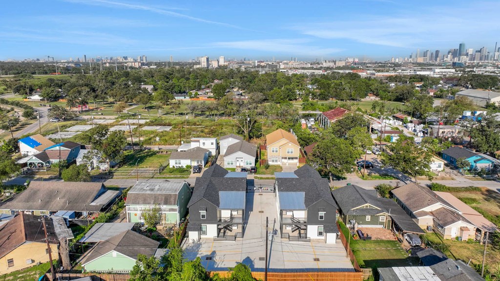 a group of houses in a neighborhood with a city in the background