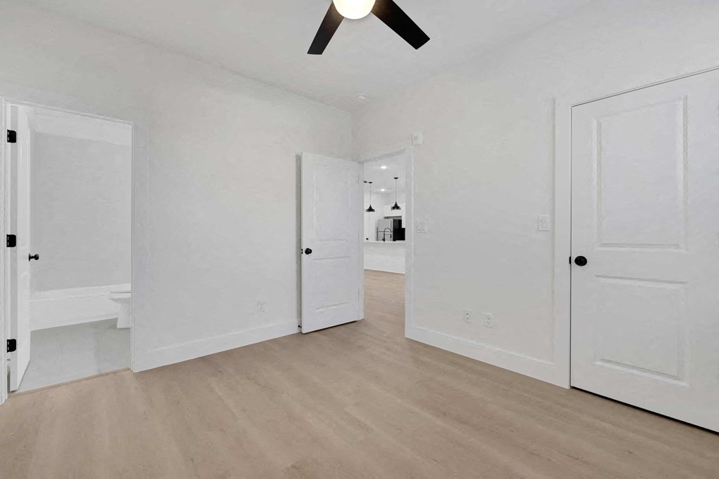 a bedroom with two closets and a door to a bathroom