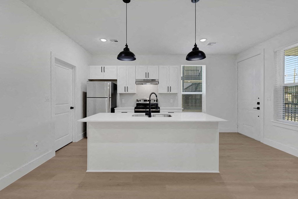 a kitchen with white cabinets and a white counter top