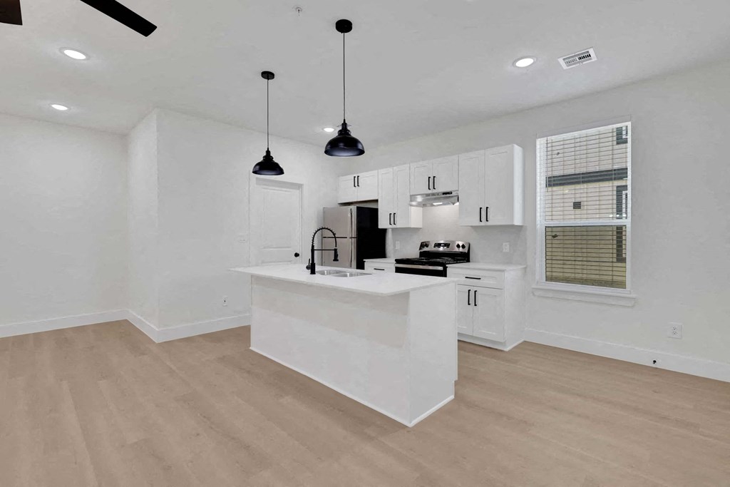 a kitchen with white cabinets and a white counter top
