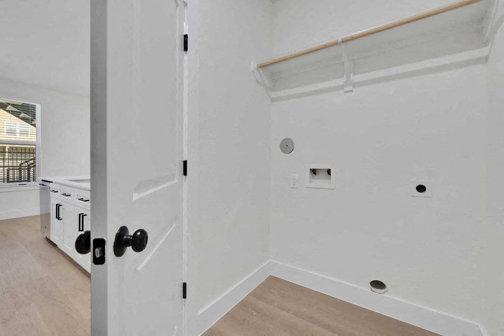 a kitchen with white walls and a white door