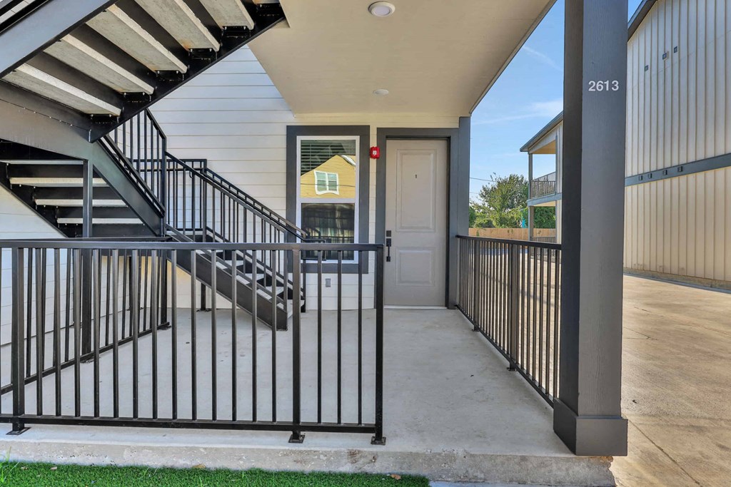 the front porch of a house with stairs and a door