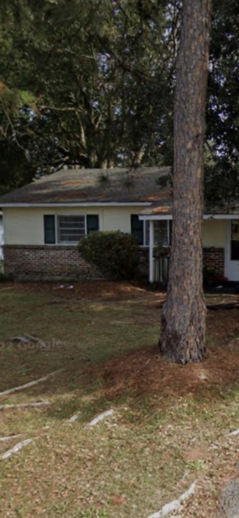 A house with a tree in front of it.