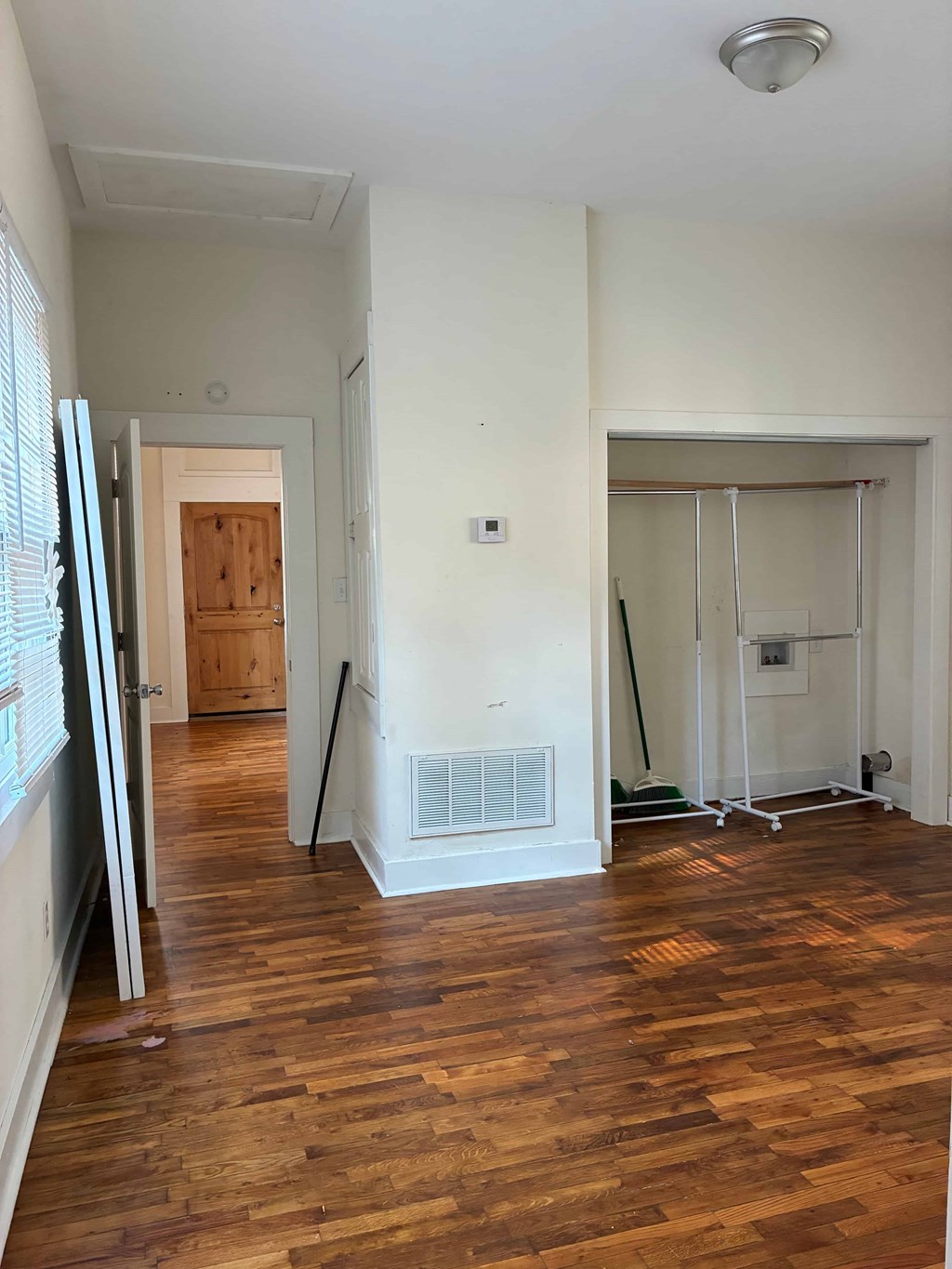 A room with wooden floors and white walls.