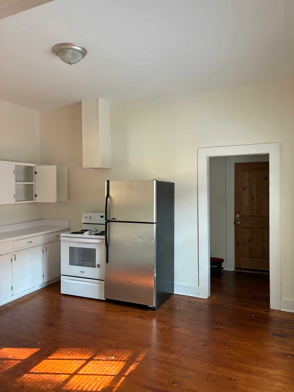 A kitchen with a refrigerator, stove, and oven.