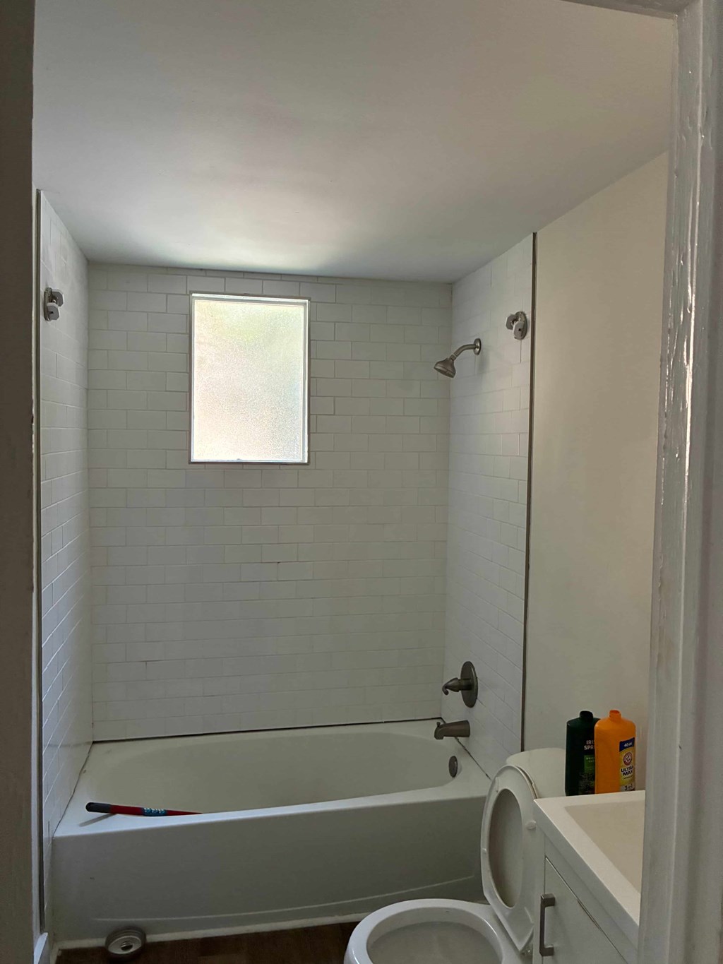 A white bathroom with a tub, toilet, and sink.