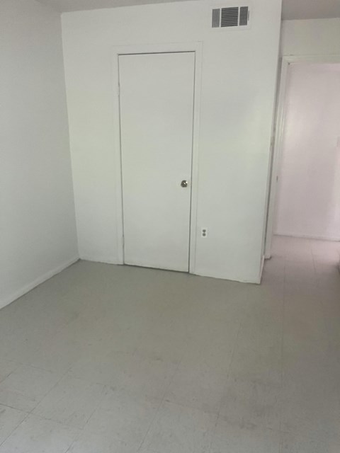 an empty room with white walls and a door