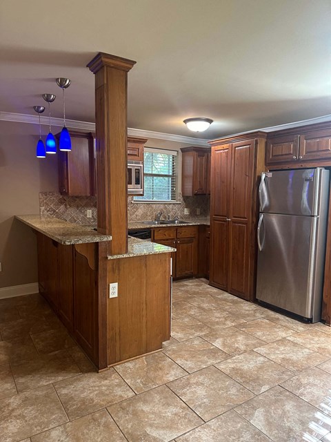 a kitchen with stainless steel appliances and wooden cabinets