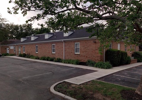 an empty parking lot in front of a brick building