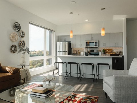 a living room with a kitchen and a table