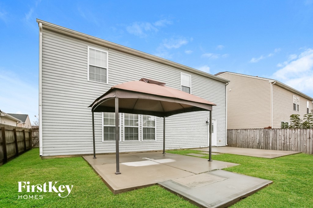 A house with a covered patio area is for sale by FirstKey Homes.