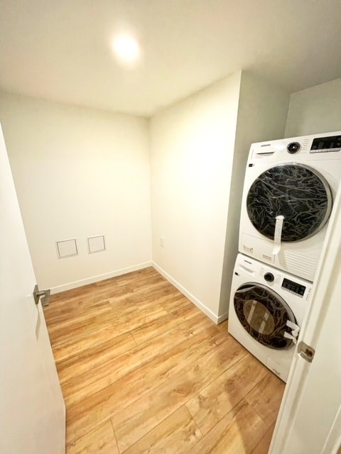 a washer and dryer in a room with a wooden floor